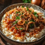 Exploring the world through food is one of life’s greatest pleasures, and Koshari Delight is a perfect gateway into the rich culinary traditions of Egypt. This iconic dish is a hearty blend of brown lentils, rice, elbow macaroni, and a tangy tomato sauce, garnished with crispy fried onions and fresh parsley. Each component comes together to create a satisfying and flavorful meal that reflects the diverse ingredients and culinary heritage of Egyptian cuisine.